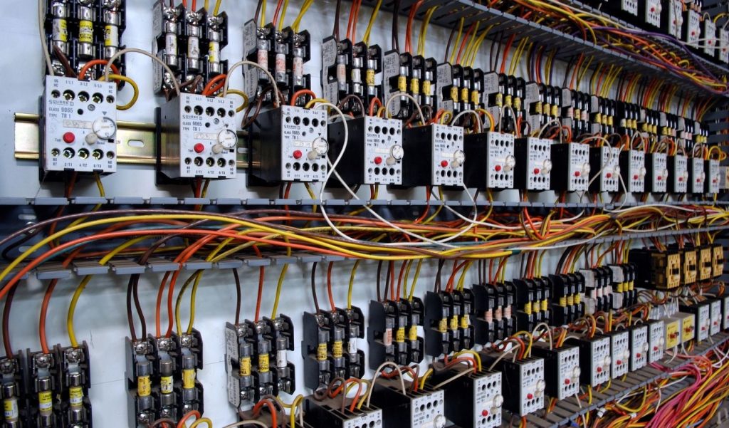 Close-up of a professionally wired electrical control panel featuring Beckhoff bus couplers and Wika smart instrumentation